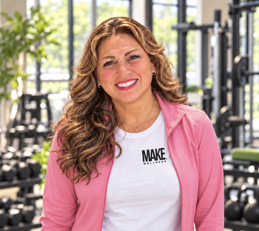 Phalynn Powers smiling in a MAKE Wellness shirt at the gym